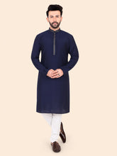 Man wearing a navy kurta with white pants