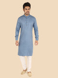 Man wearing a blue kurta with white pants