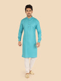 Man wearing a firozy kurta with white pants