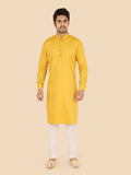 Man wearing a yellow kurta with white pants