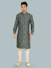 Man wearing a patterned blue kurta with white pants