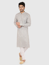 Man wearing a gray striped kurta with white pants