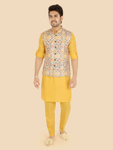 Man wearing a gold kurta with a patterned vest