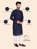Man wearing a navy kurta with white pants, highlighting features