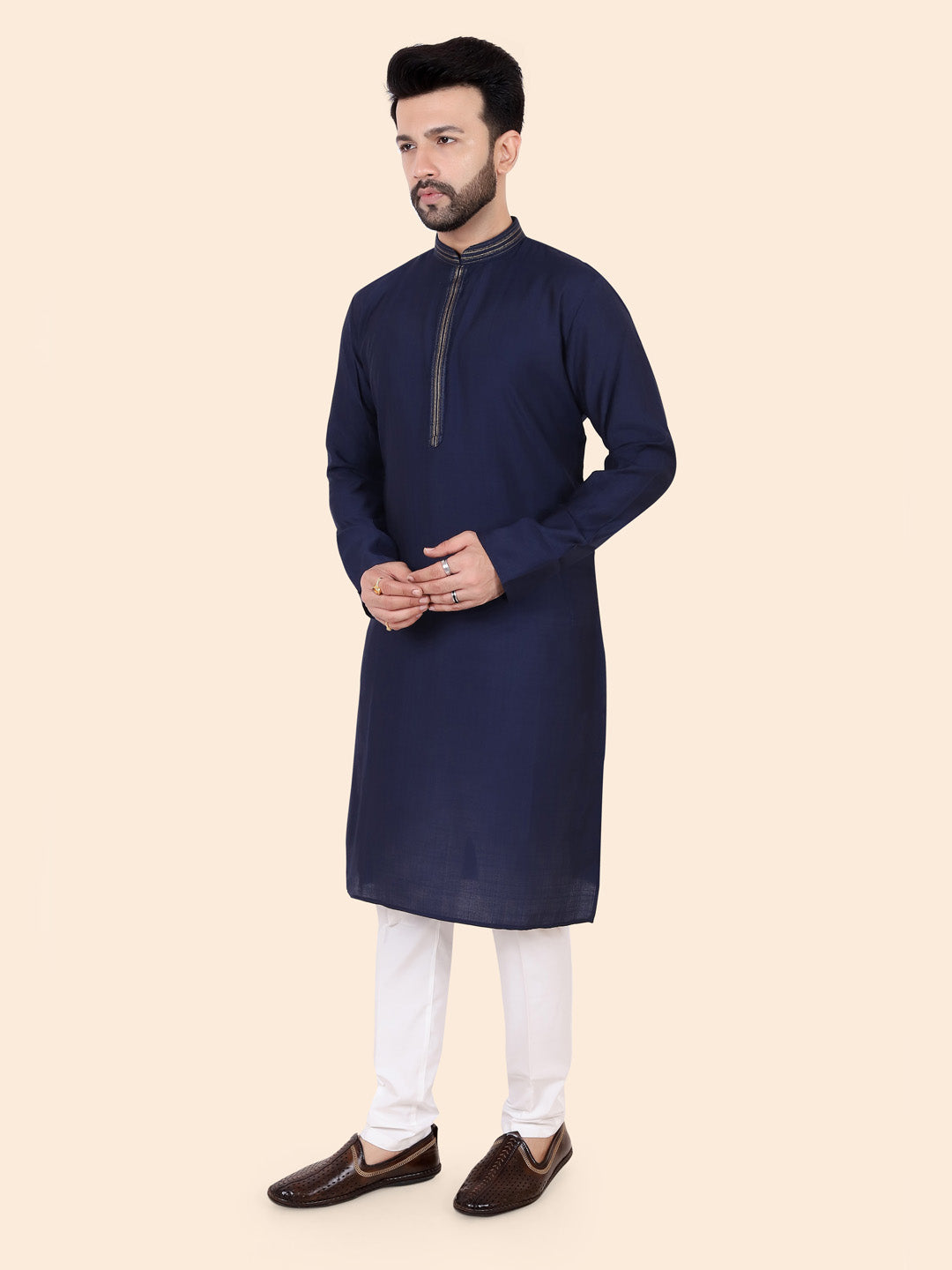Man wearing a navy kurta with white pants