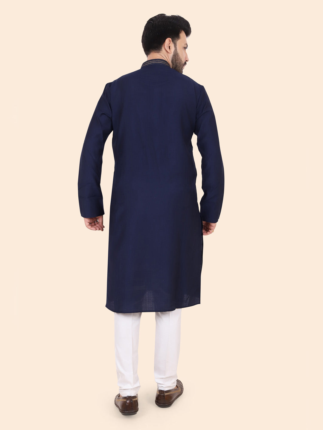 Man wearing a navy blue kurta with white pants