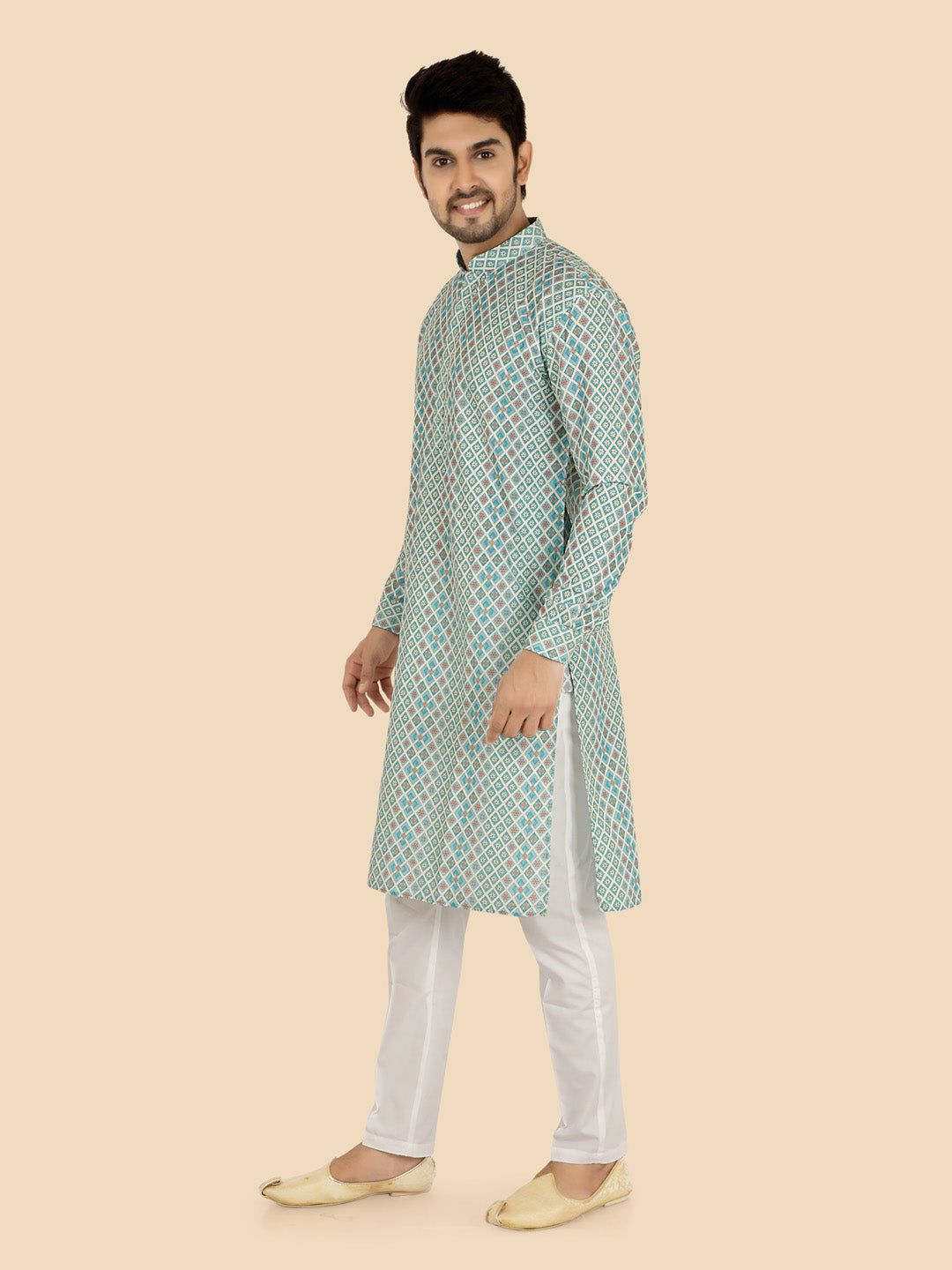 Man wearing a green and white patterned kurta with white pants