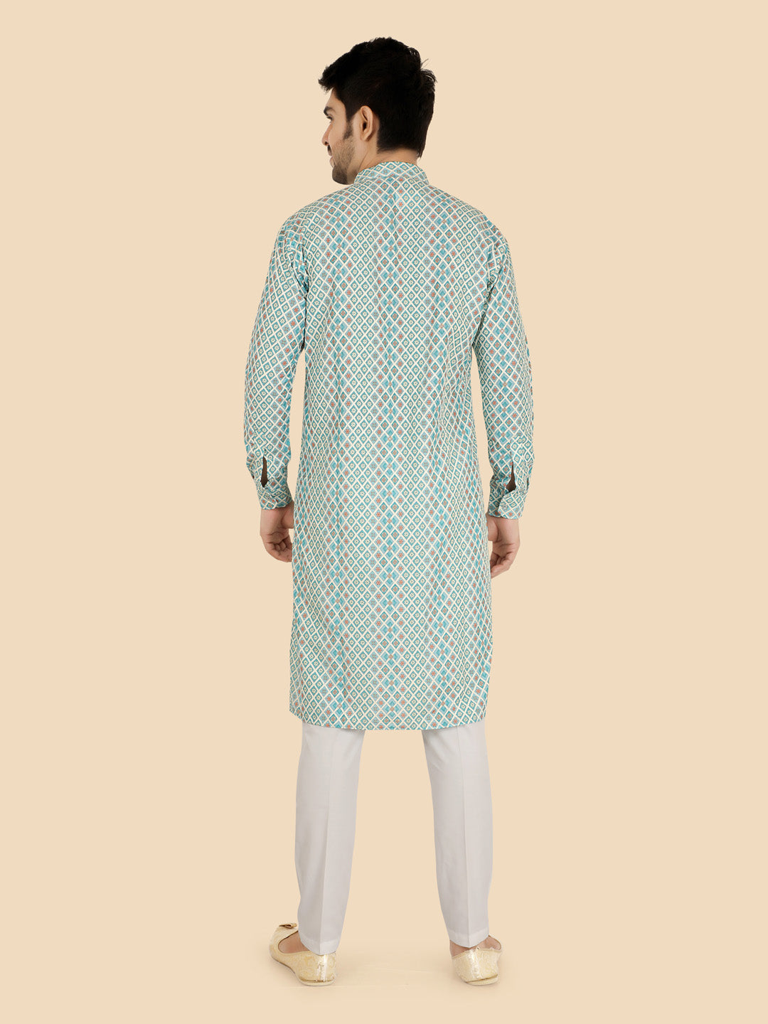 Man wearing a green patterned kurta with white pants
