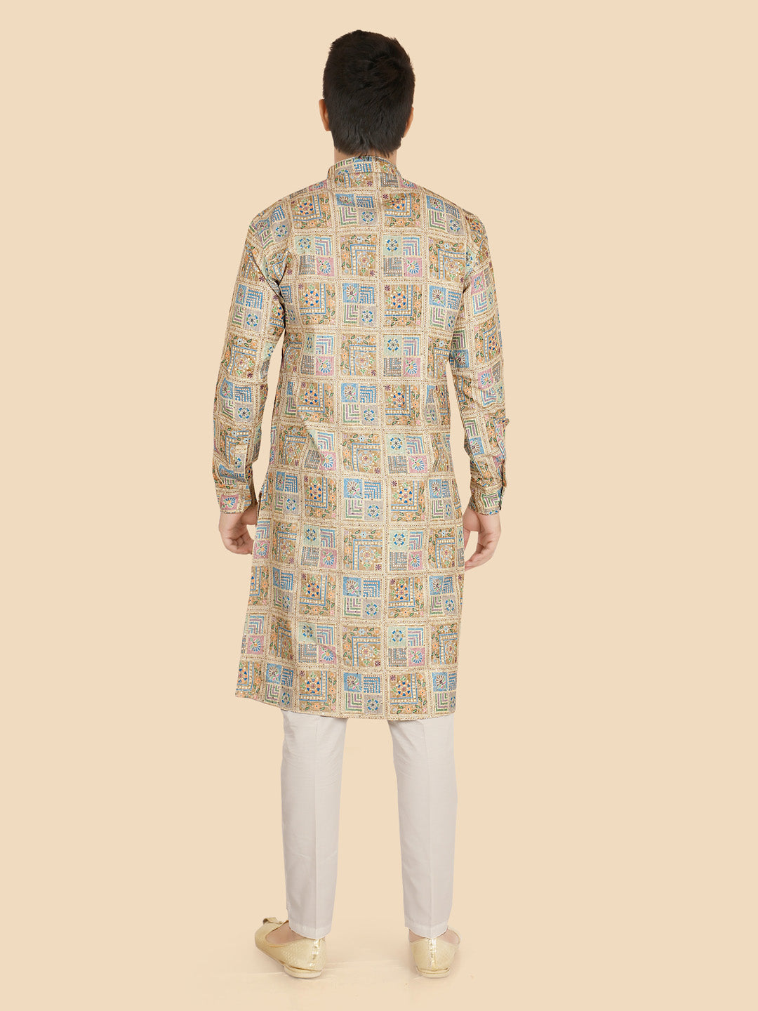 Man wearing a patterned kurta with white pants