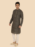 Man wearing a patterned kurta with white pants