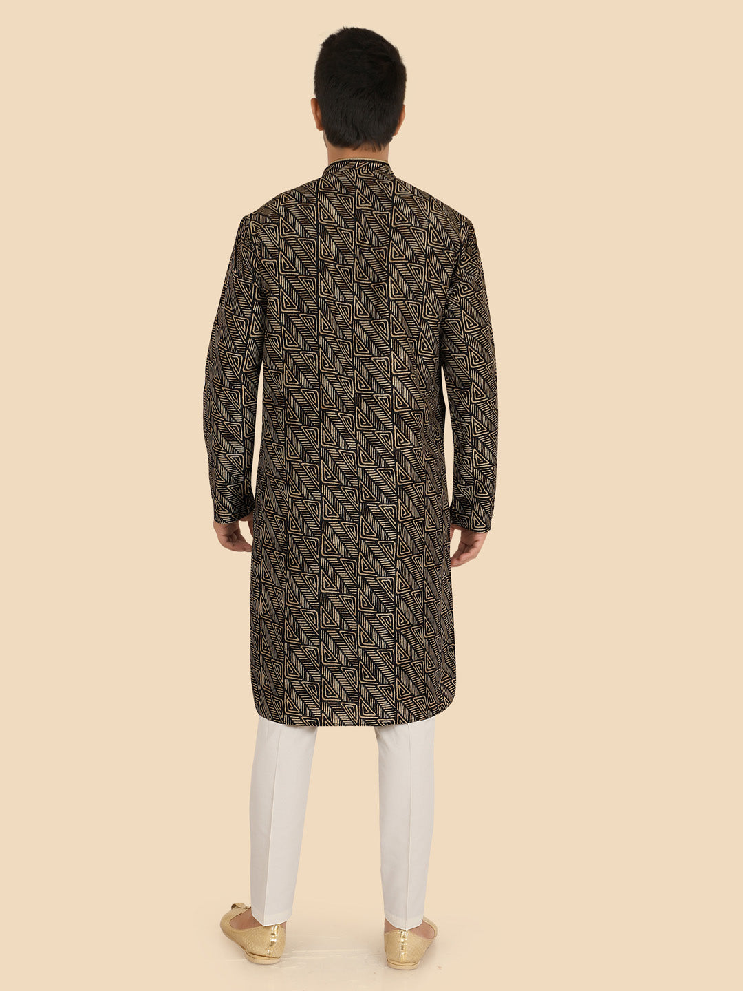Man wearing a patterned kurta with white pants