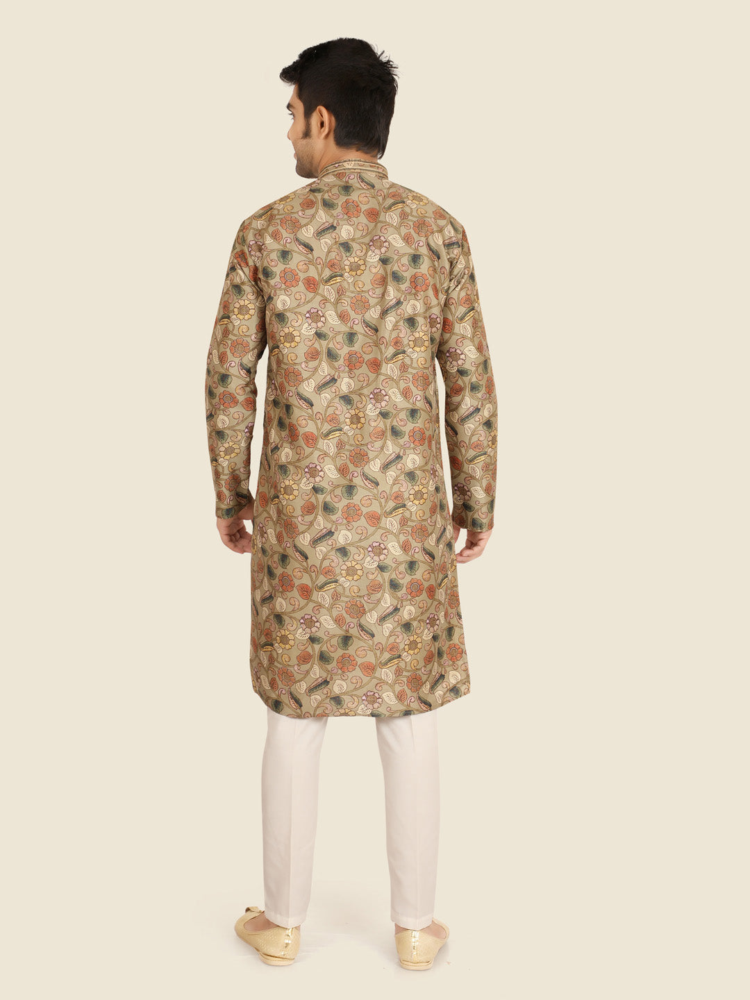 Man wearing a patterned Pista kurta with white pants 
