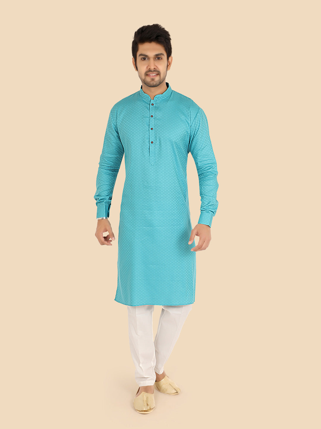 Man wearing a firozy kurta with white pants