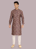 Man wearing a patterned lavender kurta with white pants 