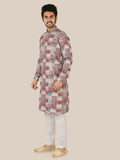 Man wearing a patterned gray kurta with white pants 