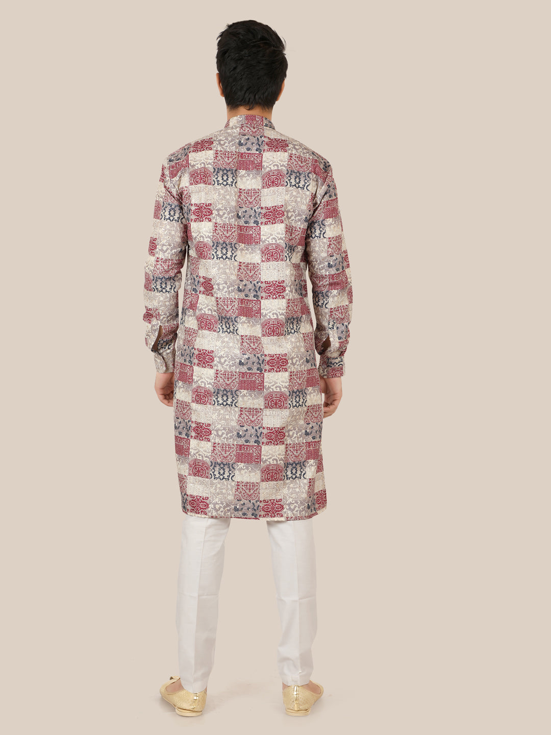 Man wearing a patterned gray kurta with white pants