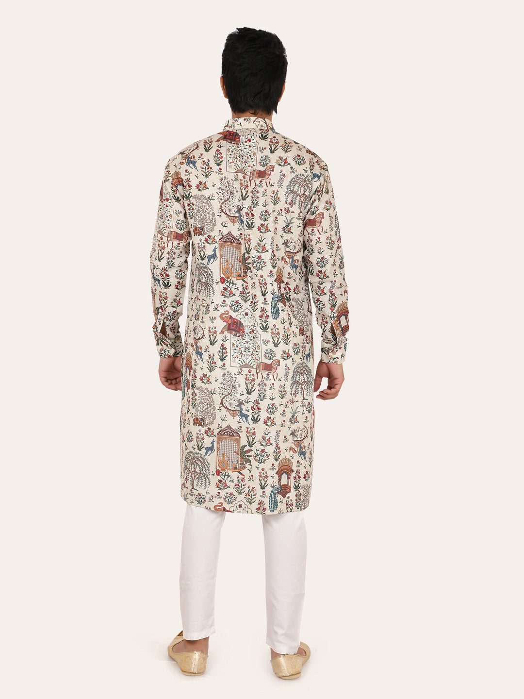 Person wearing a patterned cream kurta with white pants 
