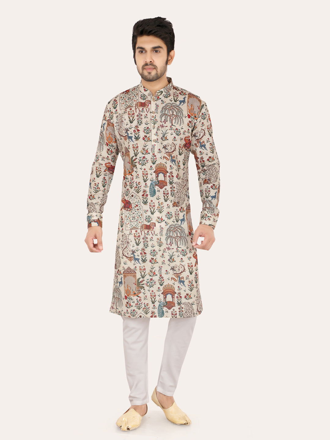 Man wearing a patterned cream kurta with white pants on a light gray background