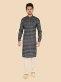 Man wearing a patterned kurta with white pants