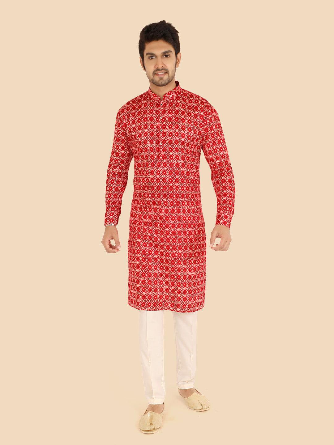 Man wearing a red patterned kurta with white pants