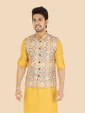 Man wearing a gold kurta with a patterned waistcoat 