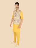 Man wearing a gold kurta with a patterned vest