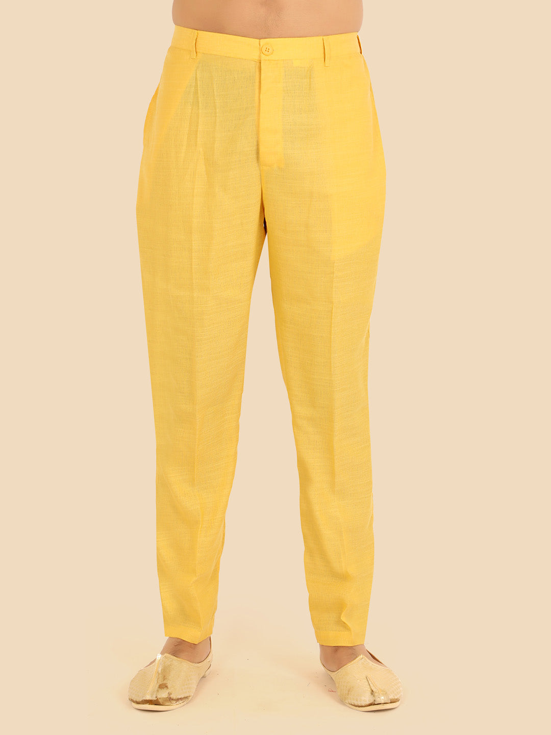 gold colour pant worn by a person