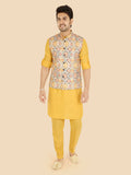 Man wearing a gold kurta with a patterned vest