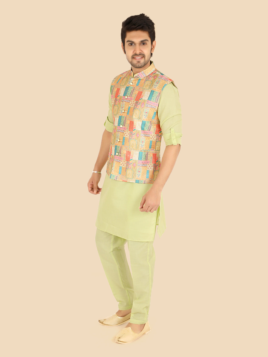 Man wearing a traditional outfit with a checkered jacket and light green or parrot green kurta